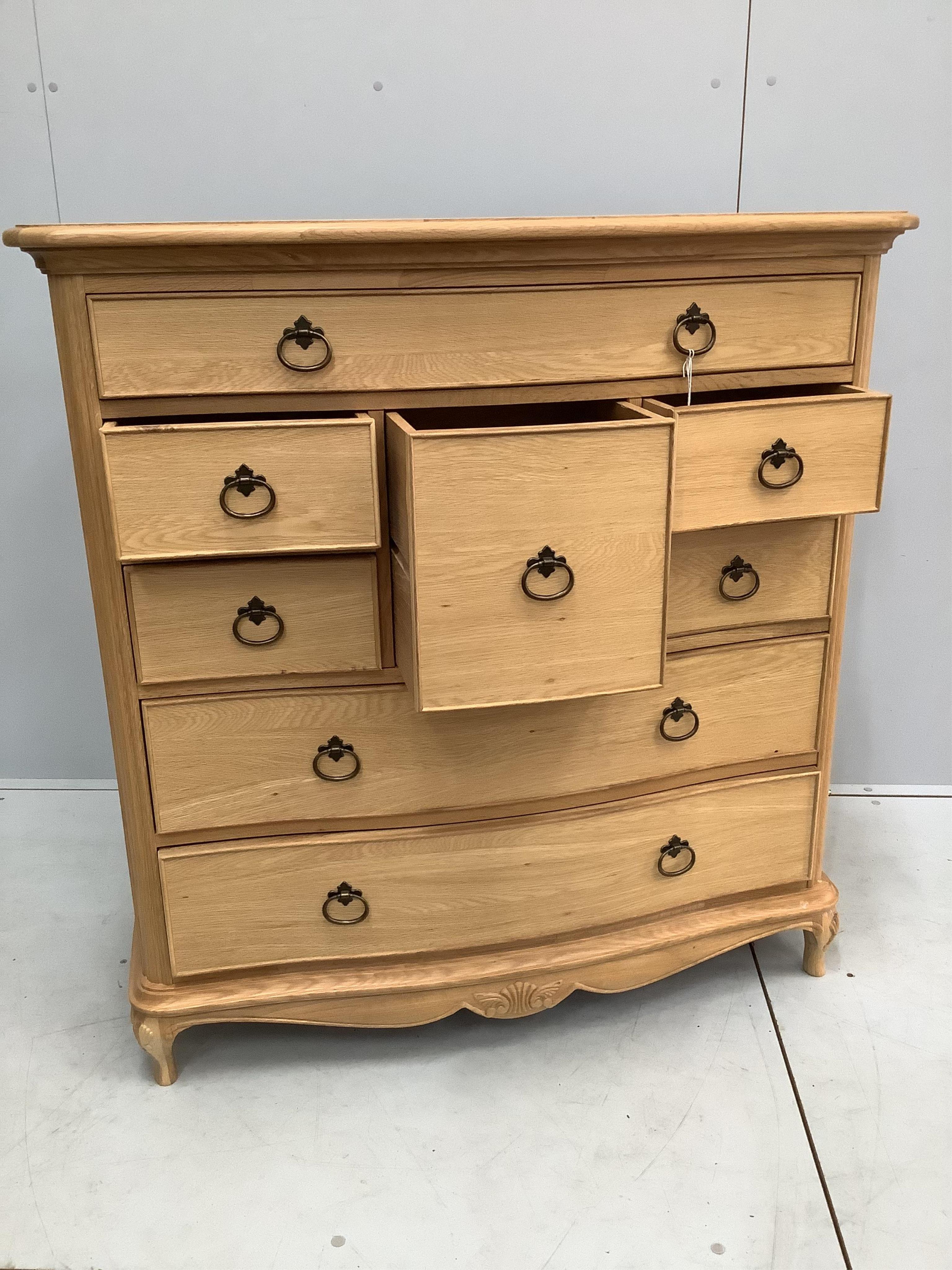 A Willis and Gambier Charlotte oak serpentine chest of eight drawers, width 108cm, depth 53cm, height 111cm